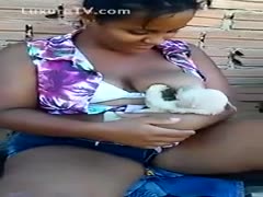 Fat ebon breastfeeding a dog 